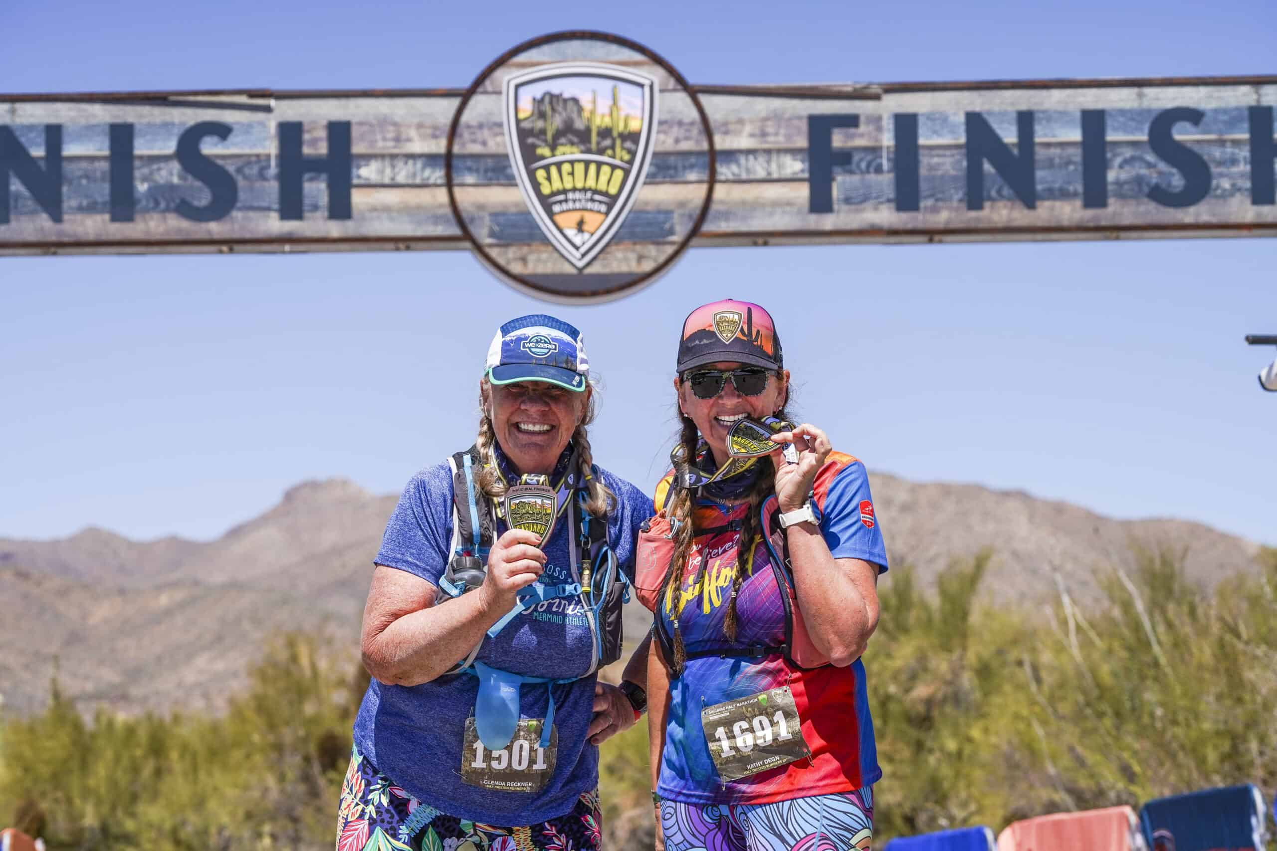 Two Seguaro Half Marathon finishers with their medals.