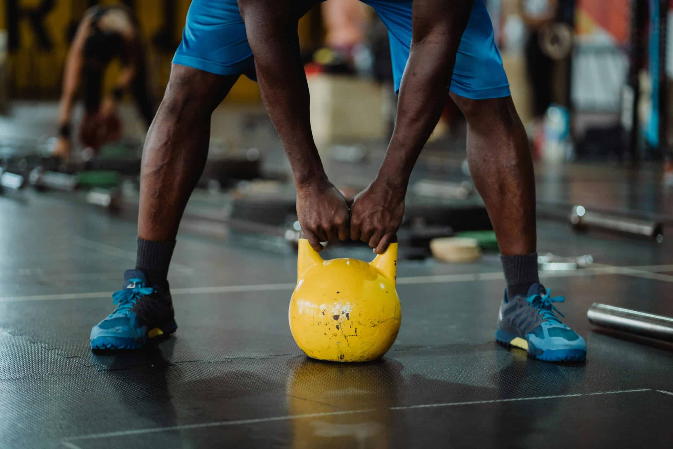 runner doing a kettlebell workout at the gym