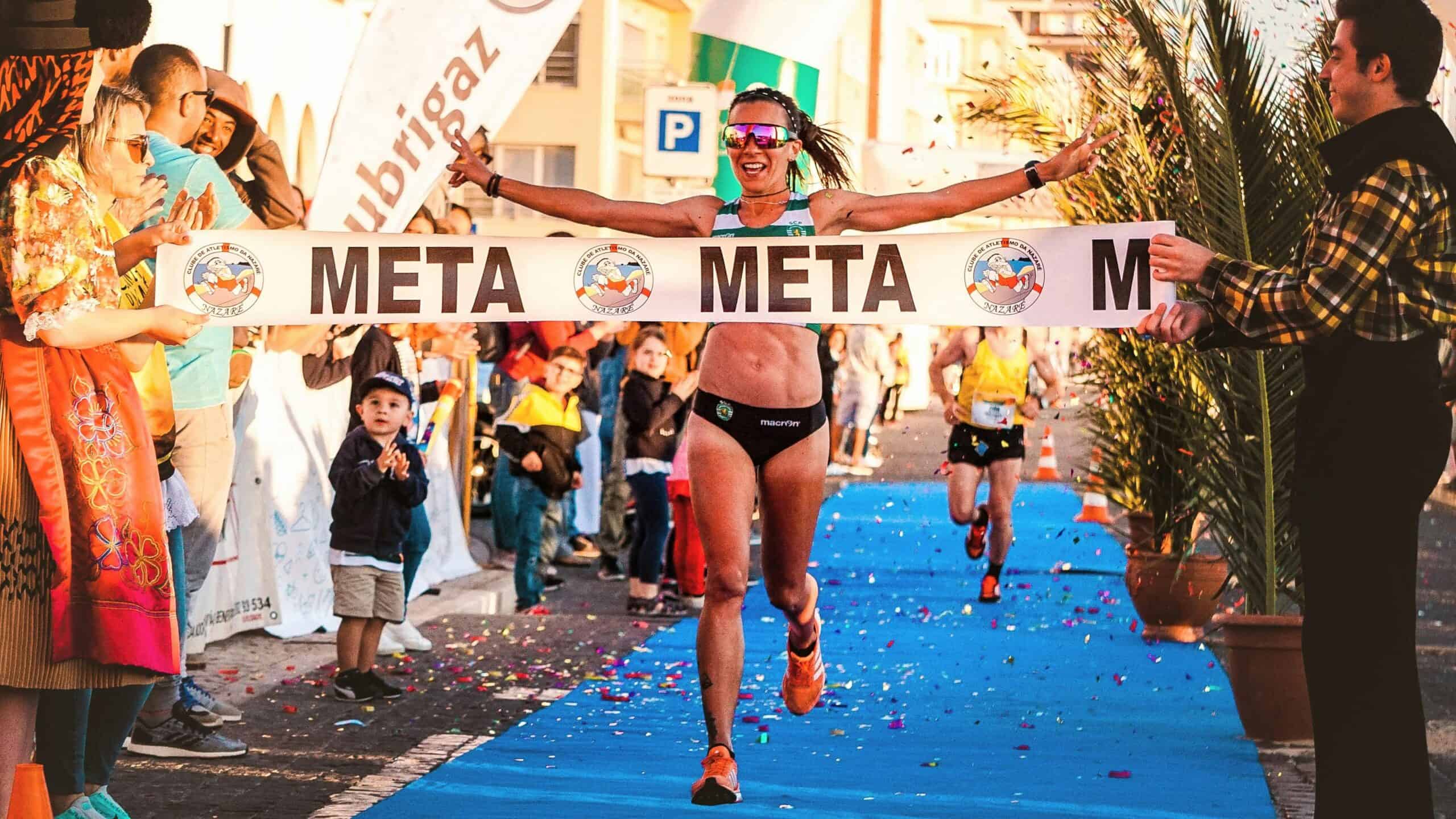 A woman finishing her race after a perfect half marathon pacing strategy.