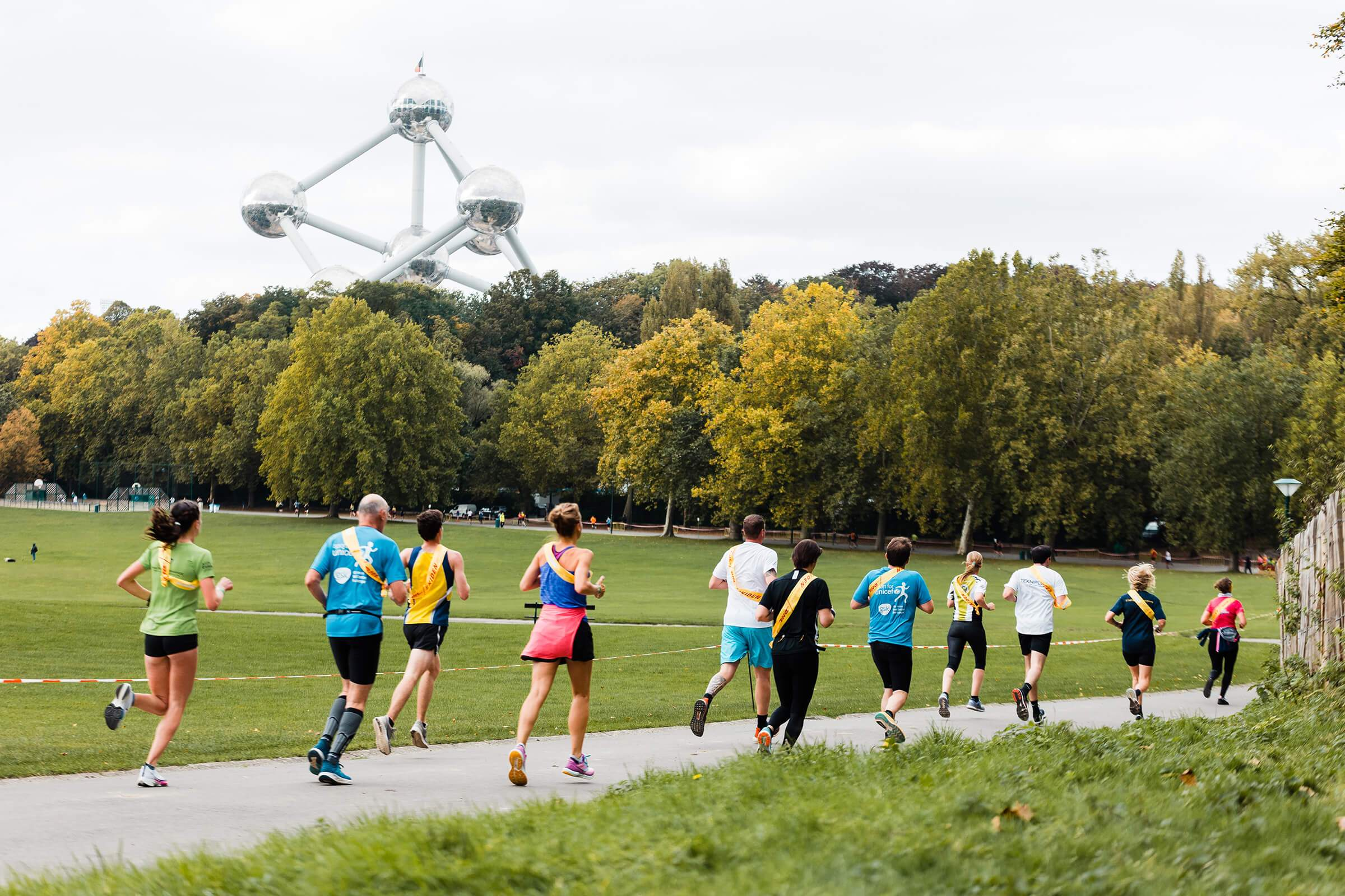 Runners in a park, running in the Brussels Half Marathon in Europe.