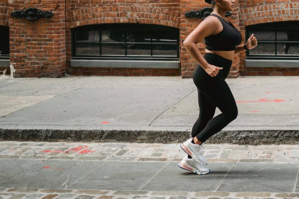 Girl running in the morning on a city street