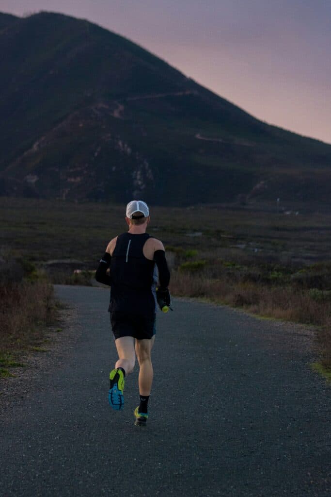 View of a man running in the morning from behind