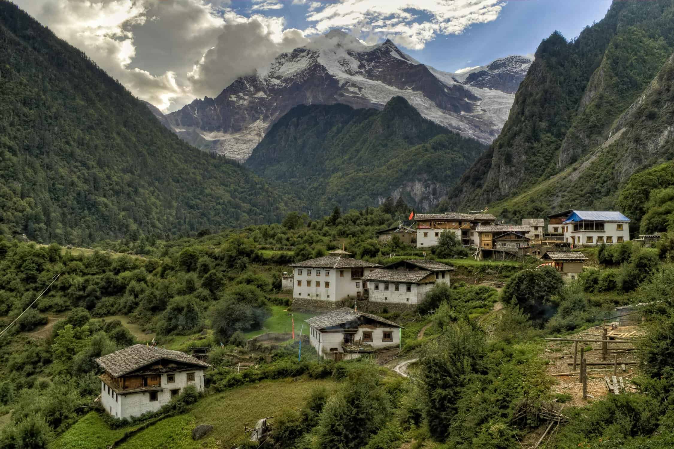 A trail runner's dream, houses in nepal set against the himalayas